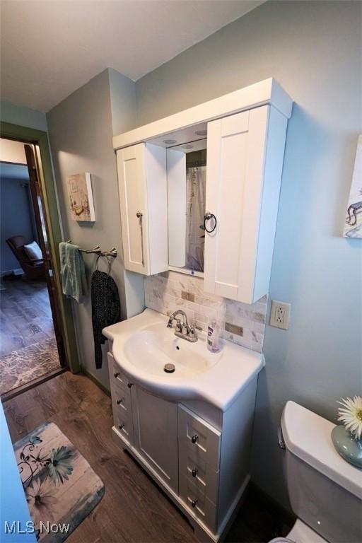 6323 Olive Ave, North Ridgeville, OH 44039 - bathroom featuring vanity, wood finished floors, and tasteful backsplash