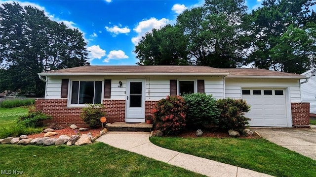 6323 Olive Ave, North Ridgeville, OH 44039 - single story home featuring brick siding, an attached garage, driveway, and a front lawn