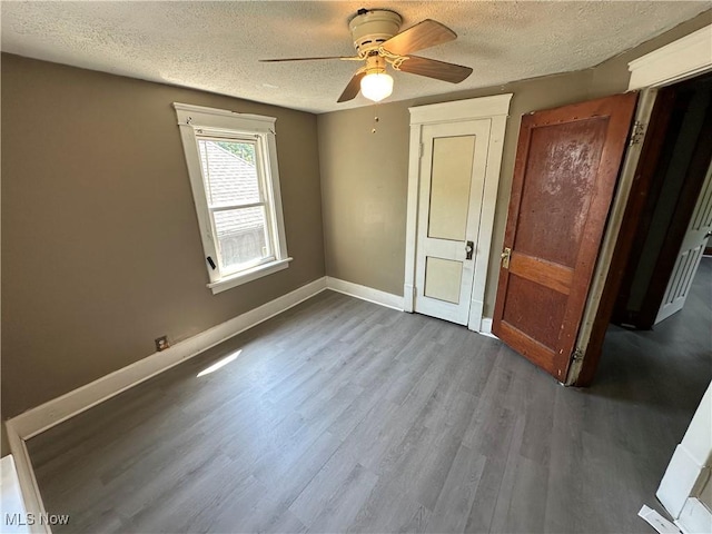 841 Kling St, Akron, OH 44311 - unfurnished bedroom with a textured ceiling, wood finished floors, and ceiling fan