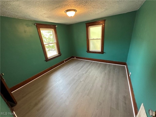 841 Kling St, Akron, OH 44311 - empty room featuring wood finished floors and a textured ceiling