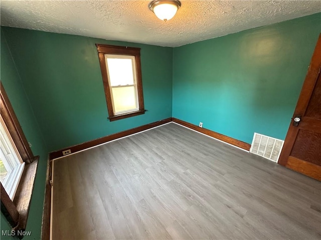 841 Kling St, Akron, OH 44311 - spare room with wood finished floors and a textured ceiling