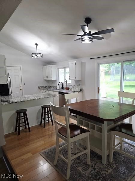 7957 Pamela Dr, North Royalton, OH 44133 - dining area with wood finished floors, healthy amount of natural light, a ceiling fan, and lofted ceiling