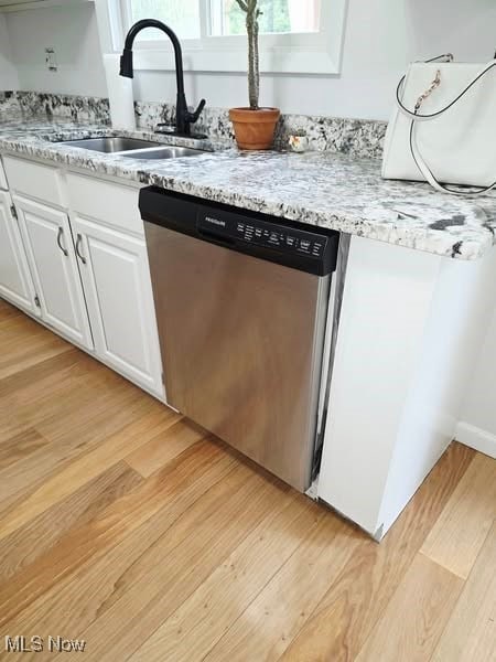 7957 Pamela Dr, North Royalton, OH 44133 - kitchen with stainless steel dishwasher, light wood finished floors, white cabinetry, and light stone countertops