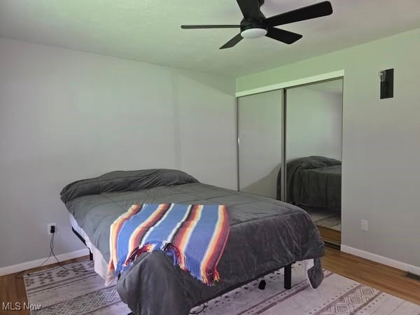 7957 Pamela Dr, North Royalton, OH 44133 - bedroom with a closet, wood finished floors, and a ceiling fan