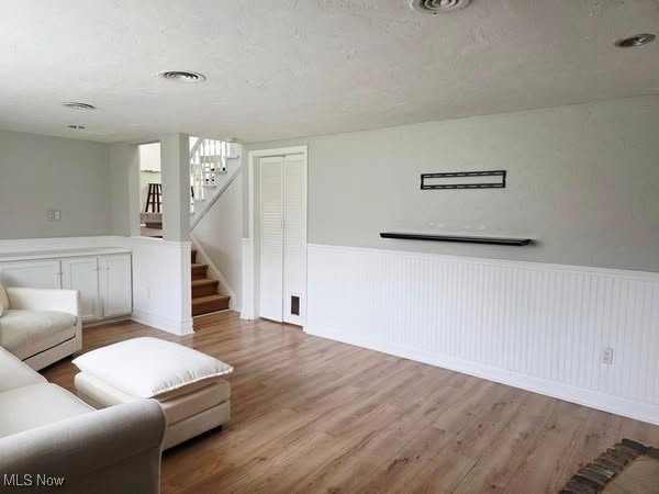 7957 Pamela Dr, North Royalton, OH 44133 - living area featuring stairs, a wainscoted wall, and wood finished floors