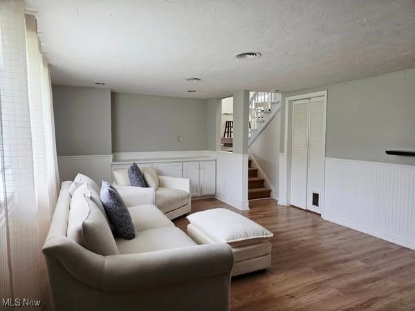 7957 Pamela Dr, North Royalton, OH 44133 - living room featuring wainscoting, stairs, and wood finished floors