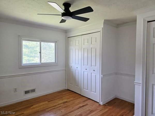 7957 Pamela Dr, North Royalton, OH 44133 - unfurnished bedroom featuring light wood finished floors, a closet, ornamental molding, and ceiling fan