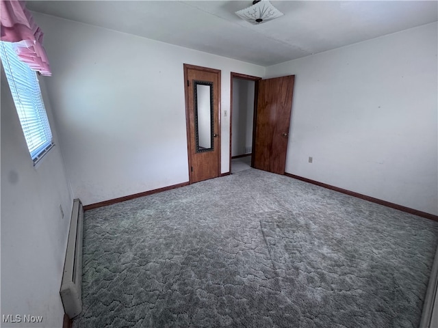 1605 Gihon Rd, Parkersburg, WV 26101 - carpeted empty room featuring a baseboard heating unit and baseboards