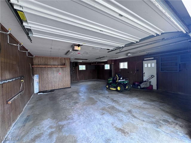 1605 Gihon Rd, Parkersburg, WV 26101 - garage featuring a garage door opener and wooden walls