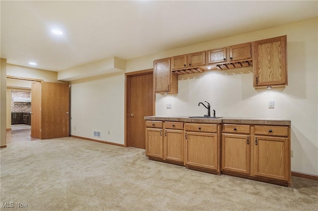1549 Galaxy Dr, Mogadore, OH 44260 - kitchen featuring brown cabinetry, light colored carpet, light countertops, and recessed lighting