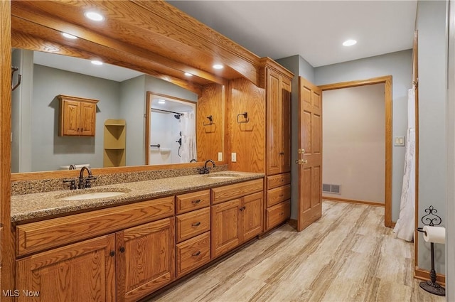 1549 Galaxy Dr, Mogadore, OH 44260 - bathroom featuring wood finished floors, double vanity, recessed lighting, and a shower with curtain