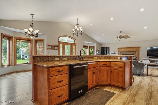 1549 Galaxy Dr, Mogadore, OH 44260 - kitchen with dishwasher, a chandelier, light wood-style flooring, open floor plan, and vaulted ceiling
