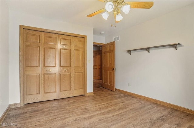 1549 Galaxy Dr, Mogadore, OH 44260 - unfurnished bedroom featuring light wood finished floors, a closet, and a ceiling fan