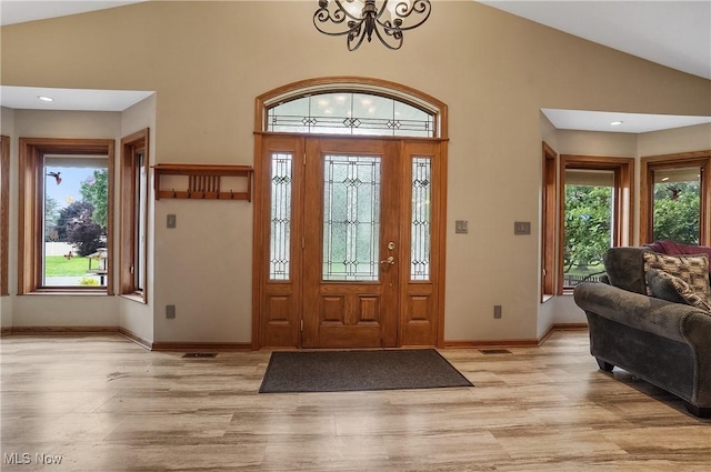 1549 Galaxy Dr, Mogadore, OH 44260 - foyer entrance with a chandelier, plenty of natural light, light wood-style flooring, high vaulted ceiling, and recessed lighting