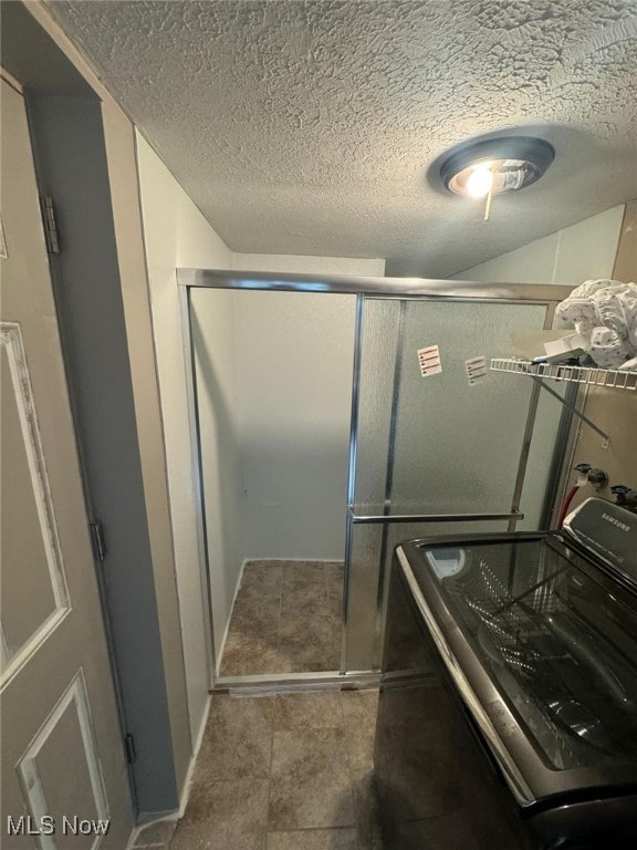 28842 Oring Rd, North Olmsted, OH 44070 - full bathroom featuring washer / clothes dryer, a textured ceiling, and a shower stall