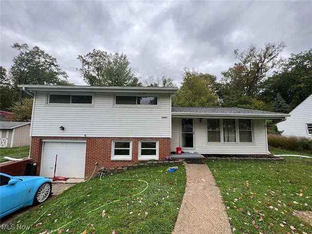 28842 Oring Rd, North Olmsted, OH 44070 - split level home with a garage, a front lawn, and brick siding