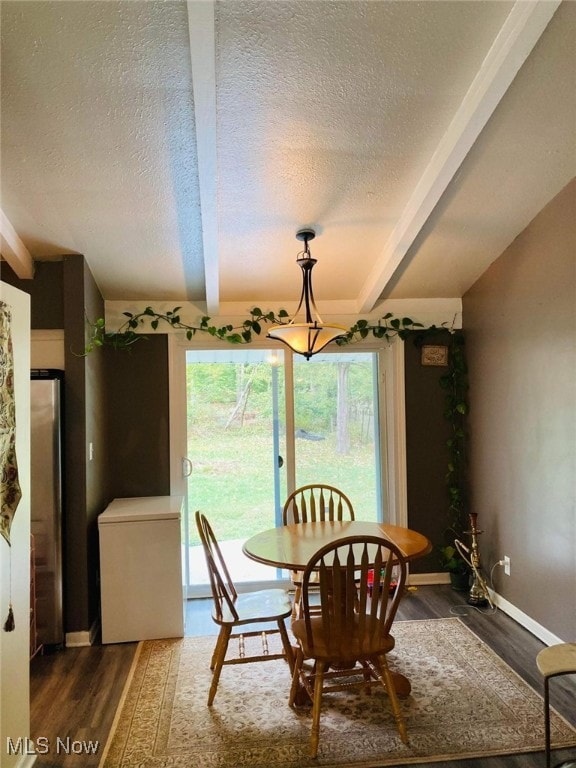 28842 Oring Rd, North Olmsted, OH 44070 - dining room with a textured ceiling, plenty of natural light, beamed ceiling, and wood finished floors
