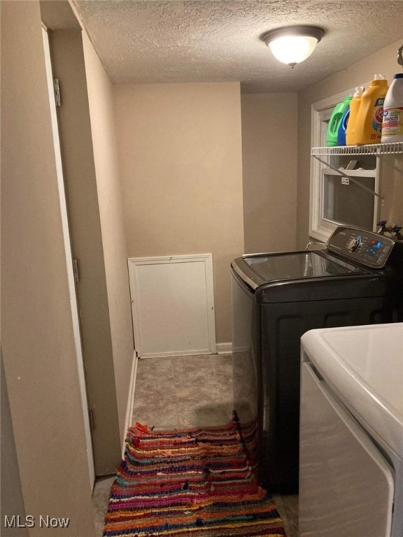 28842 Oring Rd, North Olmsted, OH 44070 - laundry area featuring separate washer and dryer and a textured ceiling