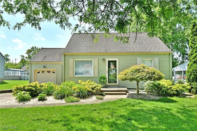 437 Hazel St, Girard, OH 44420 - cape cod-style house with a garage, a front yard, and a shingled roof