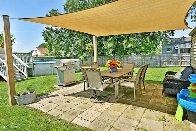 437 Hazel St, Girard, OH 44420 - fenced backyard with outdoor dining space, a patio, and a grill