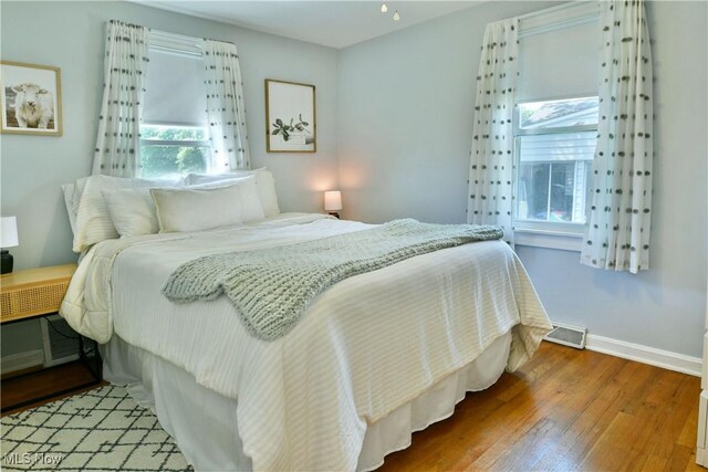 437 Hazel St, Girard, OH 44420 - bedroom featuring multiple windows and wood finished floors