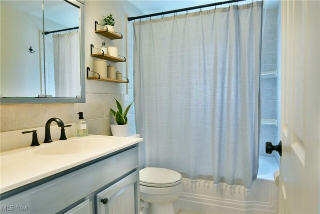 437 Hazel St, Girard, OH 44420 - bathroom featuring vanity, shower / bath combination with curtain, and decorative backsplash