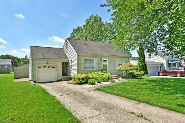 437 Hazel St, Girard, OH 44420 - cape cod-style house with a garage, driveway, a shingled roof, and a chimney