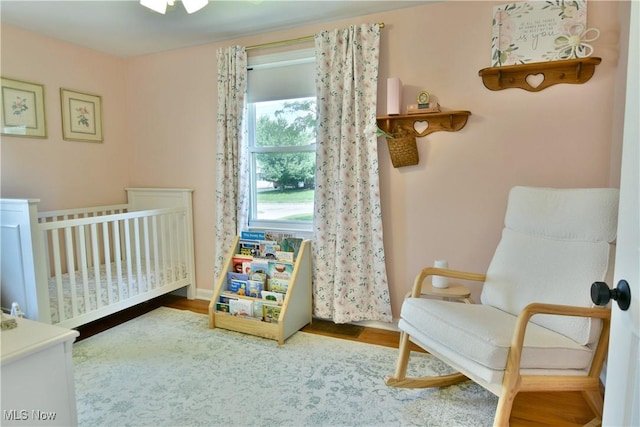 437 Hazel St, Girard, OH 44420 - bedroom featuring a crib and wood finished floors