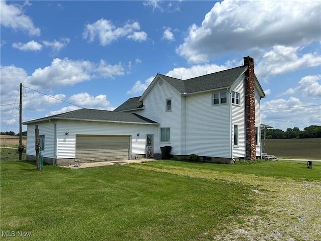 14260 Canaan Center Rd, Creston, OH 44217 - back of property featuring a chimney, a lawn, an attached garage, and roof with shingles