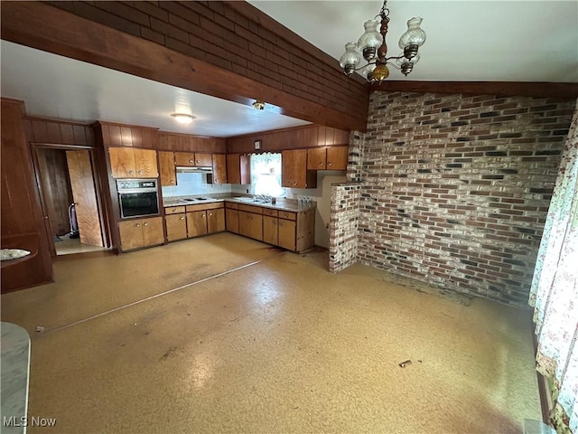 14260 Canaan Center Rd, Creston, OH 44217 - kitchen with oven, brown cabinets, a chandelier, cooktop, and brick wall
