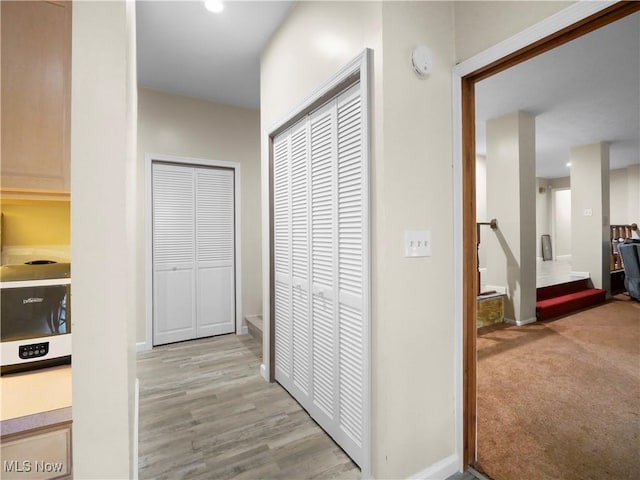 4234 Lyntz Townline Rd SW, Warren, OH 44481 - corridor with an upstairs landing, recessed lighting, and light wood-style floors