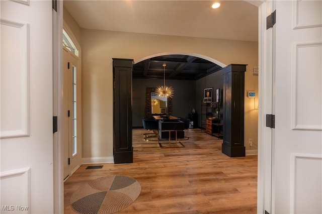 3595 Vineyard Ave NW, Canton, OH 44708 - entrance foyer with arched walkways, light wood-style flooring, coffered ceiling, recessed lighting, and beam ceiling