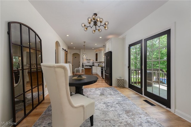 3595 Vineyard Ave NW, Canton, OH 44708 - dining room featuring arched walkways, a chandelier, light wood-style floors, and recessed lighting