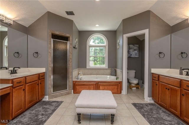 3595 Vineyard Ave NW, Canton, OH 44708 - full bathroom with a stall shower, a bath, lofted ceiling, two vanities, and tile patterned flooring