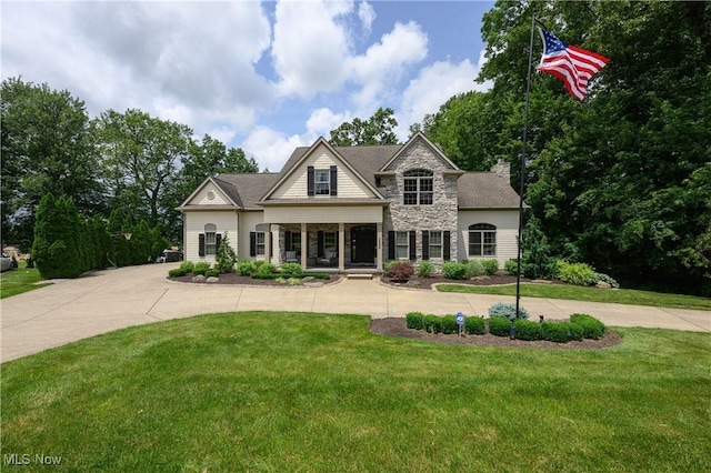 3595 Vineyard Ave NW, Canton, OH 44708 - view of front of home featuring stone siding, a front lawn, and a porch