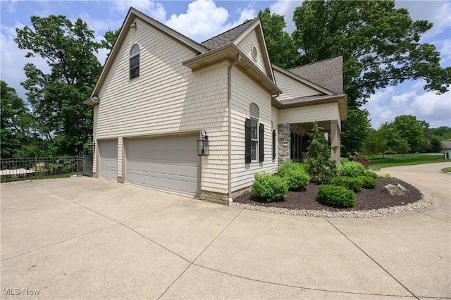 3595 Vineyard Ave NW, Canton, OH 44708 - view of side of home with a garage, driveway, and roof with shingles