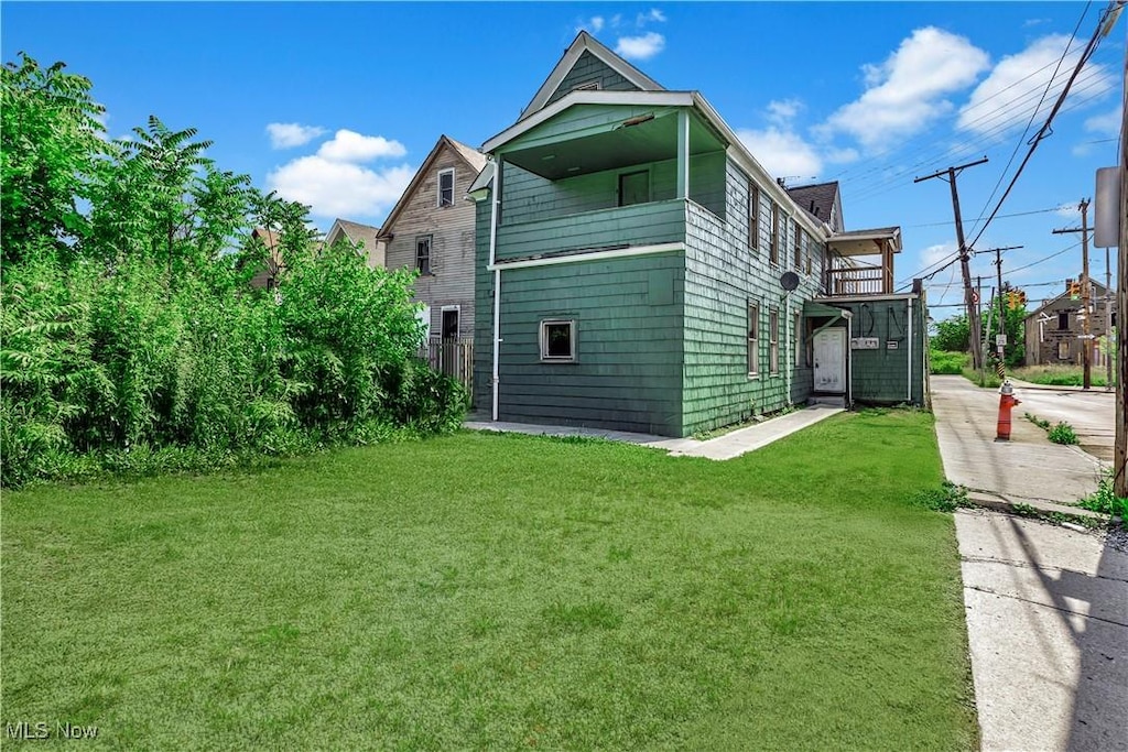 3356 W 44th St, Cleveland, OH 44109 - view of home's exterior with a lawn and a balcony