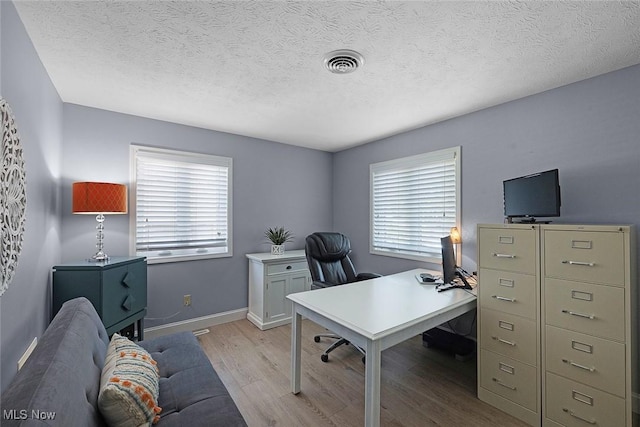 4613 Compass Rose Unit 11, Vermilion, OH 44089 - office area featuring light wood-type flooring, healthy amount of natural light, and a textured ceiling