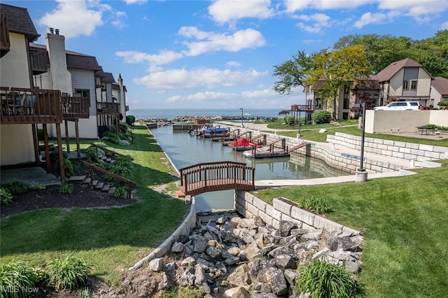 4613 Compass Rose Unit 11, Vermilion, OH 44089 - dock area featuring a water view and a yard