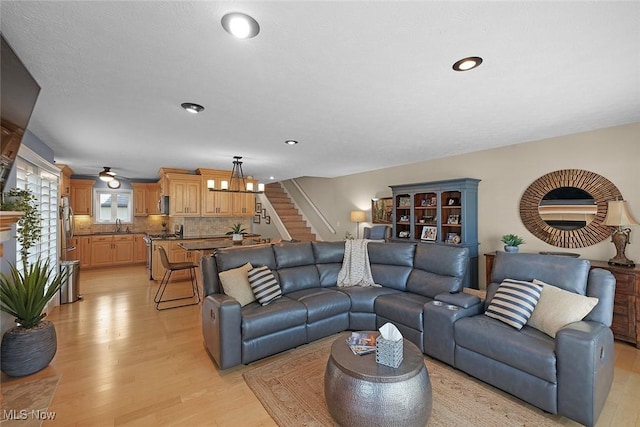 4613 Compass Rose Unit 11, Vermilion, OH 44089 - living room featuring stairs, light wood-style flooring, and recessed lighting