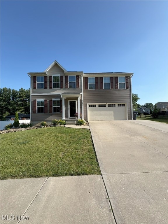 2722 Ivy Trl, Ravenna, OH 44266 - view of front of property featuring concrete driveway, an attached garage, and a front yard