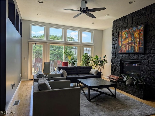 1949 Columbus Rd, Cleveland, OH 44113 - living room featuring a fireplace, wood finished floors, a ceiling fan, and recessed lighting