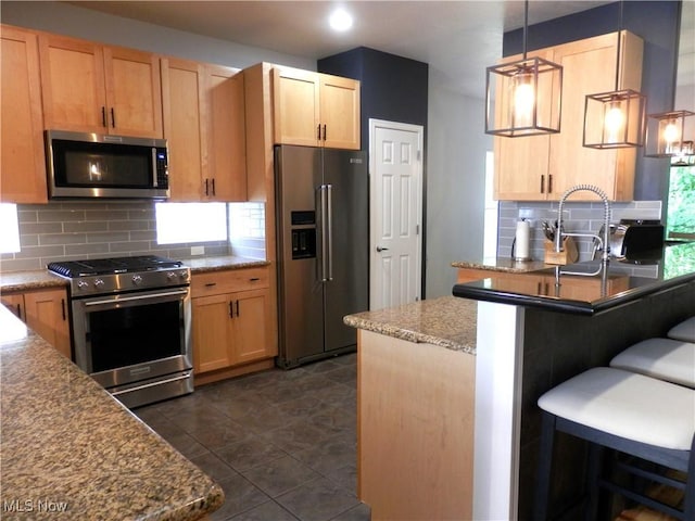 1949 Columbus Rd, Cleveland, OH 44113 - kitchen featuring stainless steel appliances, decorative backsplash, light brown cabinets, a breakfast bar area, and recessed lighting