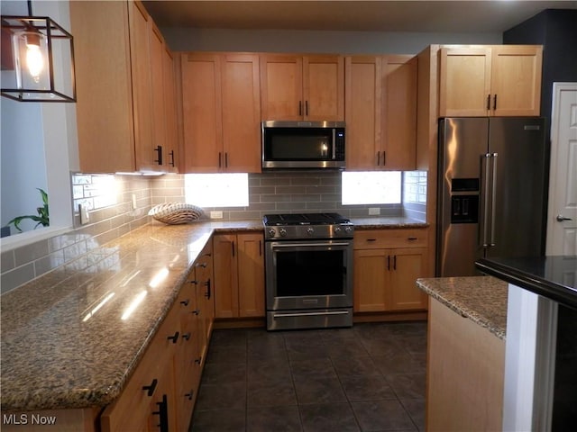 1949 Columbus Rd, Cleveland, OH 44113 - kitchen featuring appliances with stainless steel finishes, backsplash, dark tile patterned flooring, stone counters, and light brown cabinetry