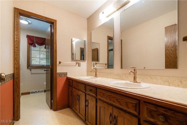 221 Winston Ave NE, North Canton, OH 44720 - bathroom with double vanity and toilet