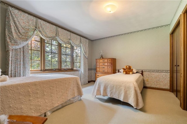 221 Winston Ave NE, North Canton, OH 44720 - carpeted bedroom featuring wallpapered walls and a closet