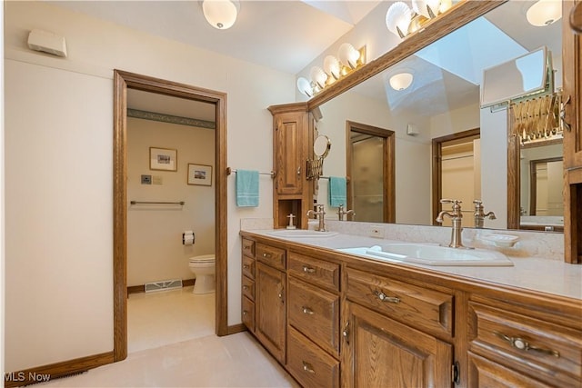 221 Winston Ave NE, North Canton, OH 44720 - full bathroom with double vanity and toilet
