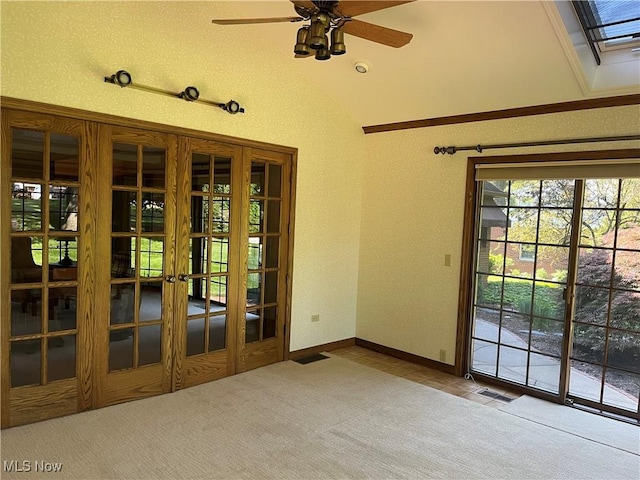 221 Winston Ave NE, North Canton, OH 44720 - carpeted empty room with vaulted ceiling, french doors, tile patterned flooring, and ceiling fan