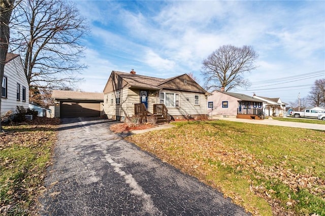 3214 Quentin Dr, Youngstown, OH 44511 - view of front facade with an outbuilding, a front lawn, driveway, and a chimney