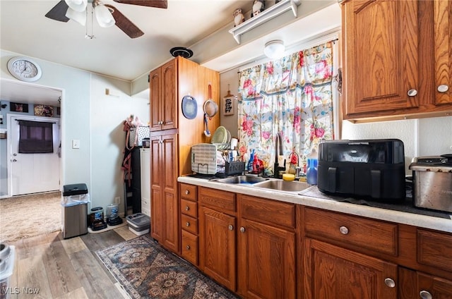 3214 Quentin Dr, Youngstown, OH 44511 - kitchen featuring a ceiling fan, light countertops, wood finished floors, and brown cabinetry